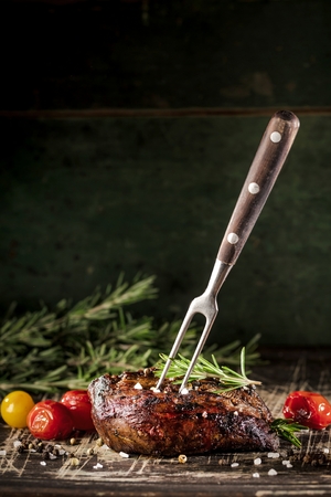 Fresh fillet steak on wooden board closeup.の写真素材