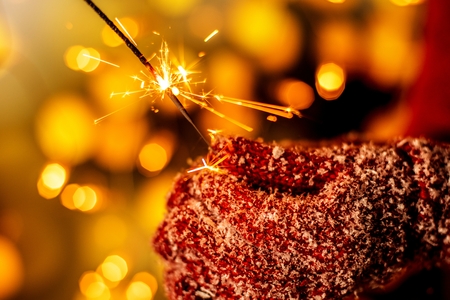 women holding christmas candel in warm glovesの写真素材
