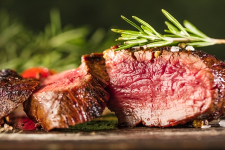 Fresh fillet steak on wooden board closeup.の写真素材