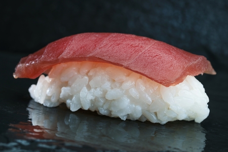 Sushi Set sashimi and sushi rolls served on stone slateの写真素材