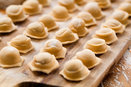 Ravioli homemade. Fresh dough and ravioli traditional to the rustic table.の写真素材