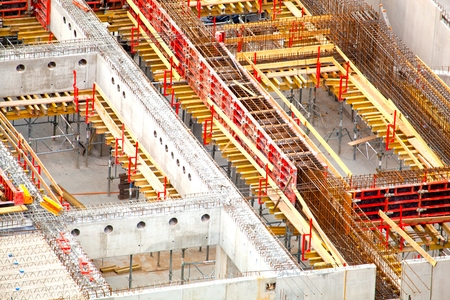 Unfinished cement building at a construction site in the summer.