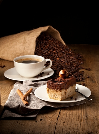 chocolate cake on wooden table with a coffee cupの写真素材