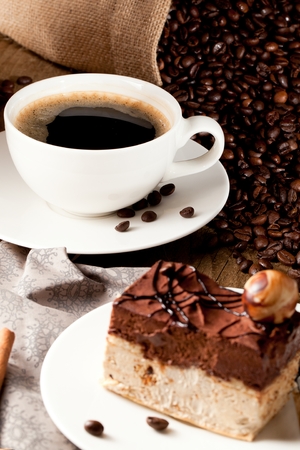 chocolate cake on wooden table with a coffee cupの写真素材