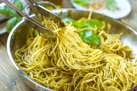 Pasta spaghetti with basil cream and cheese. Top view on grey stone table. Vegetarian vegetable pasta.の写真素材