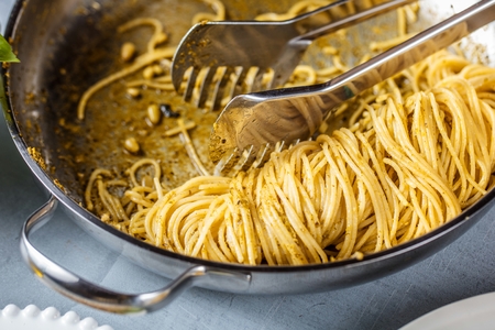Pasta spaghetti with basil cream and cheese. Top view on grey stone table. Vegetarian vegetable pasta.の写真素材