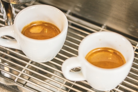 Close-up of espresso pouring from coffee machine. Professional coffee brewingの写真素材