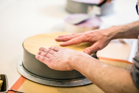 men in pastry shop bakery making pies and cakes ready.の写真素材