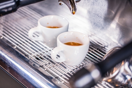 Close-up of espresso pouring from coffee machine. Professional coffee brewingの写真素材