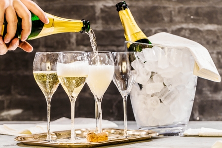 Bottle of champagne and filled glasses decorated in festive theme.の写真素材