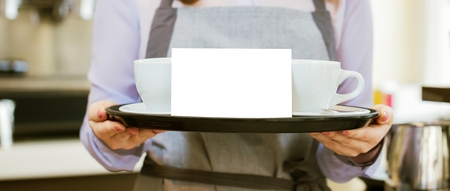Women Barista using coffee machine for making coffee in the cafe.の写真素材