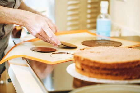 Men in pastry shop bakery making pies and cakes readyの写真素材