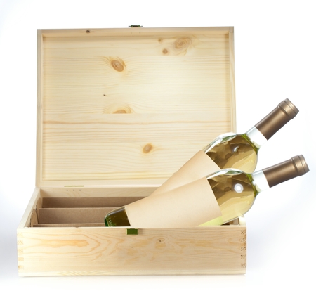 Wine bottle in wooden box closeup on white backgound.の写真素材