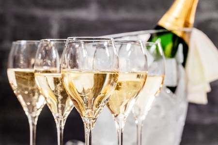 Bottle of champagne and filled glasses decorated in festive theme.の写真素材