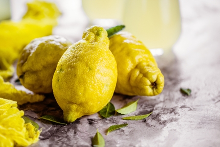 Fresh organic fruit - lemons on wood background selective focusの写真素材