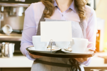 Women Barista using coffee machine for making coffee in the cafe.の写真素材