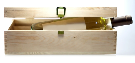 Wine bottle in wooden box closeup on white backgound.の写真素材