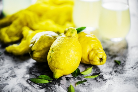 Fresh organic fruit - lemons on wood background selective focusの写真素材