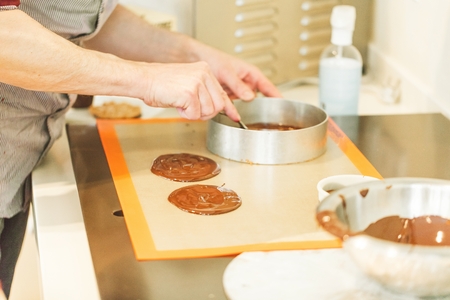 Men in pastry shop bakery making pies and cakes ready.の写真素材