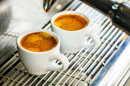 Close-up of espresso pouring from coffee machine. Professional coffee brewingの写真素材