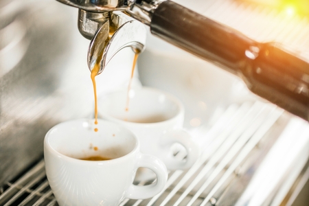 Close-up of espresso pouring from coffee machine. Professional coffee brewingの写真素材