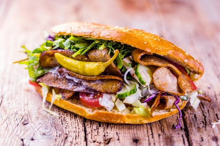Delicious kebab sandwich on wooden background closeup.の写真素材