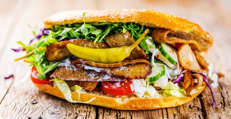 Delicious kebab sandwich on wooden background closeup.の写真素材