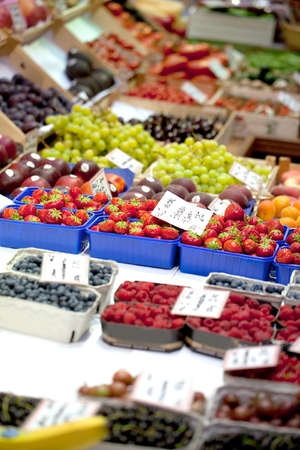 Fruit market with various colorful fresh fruits and vegetablesの写真素材