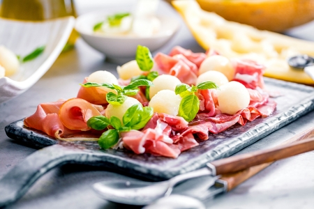 Concept of italian food with melon and prosciutto, selective focusの写真素材