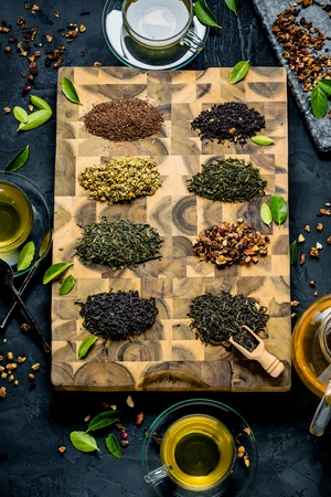 Assortment of dry tea on wooden background.の写真素材