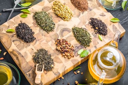 Assortment of dry tea on wooden background.の写真素材