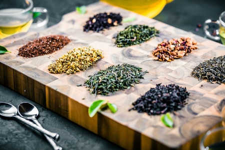 Assortment of dry tea on wooden background.の写真素材