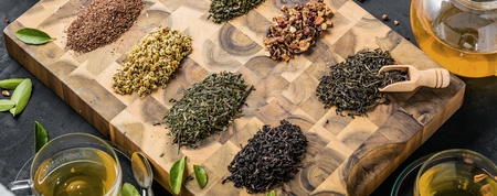 Assortment of dry tea on wooden background.の写真素材