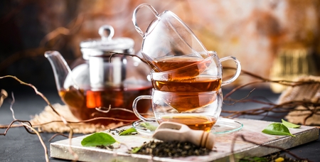 Cup of freshly brewed black tea,warm soft light, darker background.の写真素材