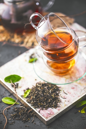 Cup of freshly brewed black tea,warm soft light, darker background.の写真素材