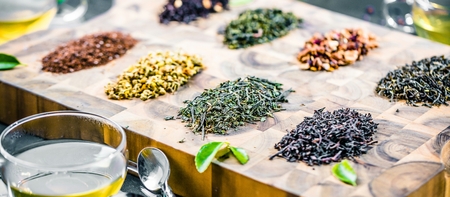 Assortment of dry tea on wooden background.の写真素材