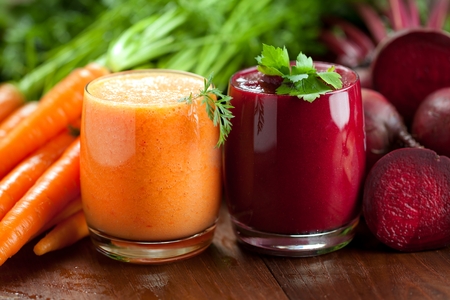 Mix beetroot and carrot juices on wooden backgroundの写真素材