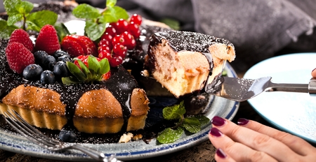 Delicious tart with fresh strawberries, raspberries and currants on the table
