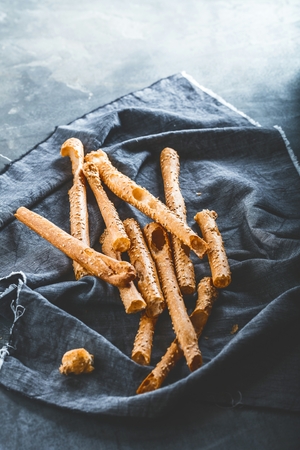 Grissini - traditional Italian salty breadsticks sprinkled with poppy seedsの写真素材