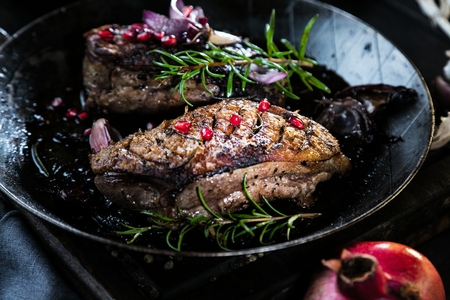 Close-up of sliced roasted duck breast fillet with baked carrotsの写真素材