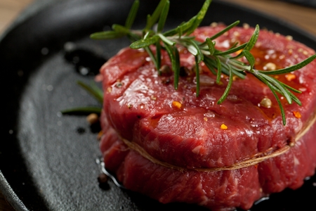 Raw beef steak on a dark wooden tableの写真素材