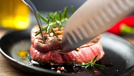 Fresh grilled meat. Grilled beef steak medium rare on wooden cutting board. Top view.の写真素材