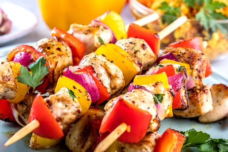 Grilled skewers of vegetables and meat on the Tableの写真素材