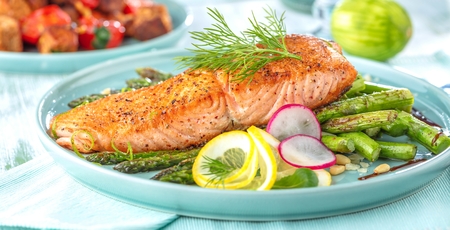 Grilled salmon and asparagus on wooden table close up.の写真素材