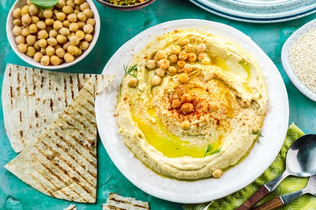 Healthy Homemade Creamy Hummus with Olive Oil and Pitaの写真素材
