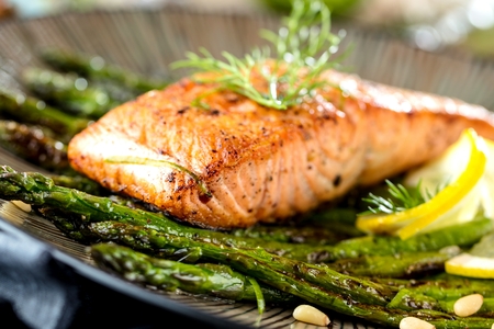 Grilled salmon and asparagus on wooden table close up.の写真素材