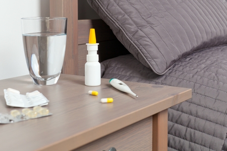 Man feeling bad lying in the bed and coughing