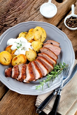Duck breast fillet closeup on wooden background.の写真素材