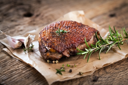 Duck breast fillet closeup on wooden background.の写真素材