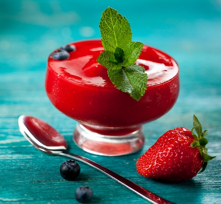 Strawberry jam in a jar on wooden backgroundの写真素材